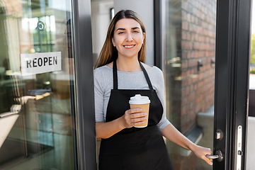 Image showing happy woman with coffee and reopen banner on door