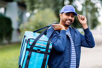 Image showing happy smiling indian delivery man with bag in city