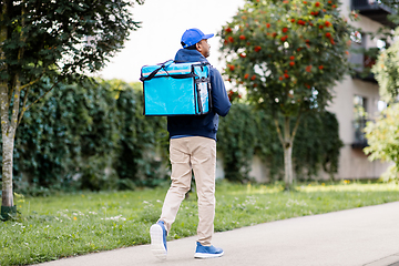 Image showing indian delivery man with bag walking in city