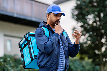 Image showing indian delivery man with bag and phone