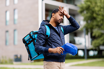 Image showing tired indian delivery man with bag in city