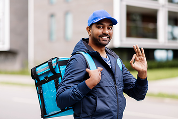 Image showing happy indian delivery man with bag showing ok