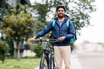 Image showing indian delivery man with bag and bicycle in city