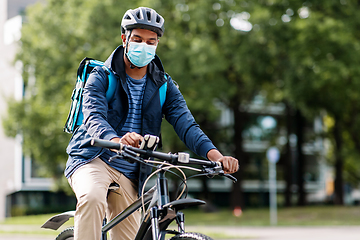 Image showing delivery man in mask with smatphone riding bicycle