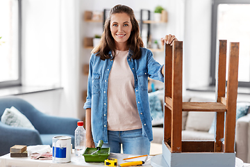 Image showing happy smiling woman renovating old table at home