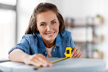 Image showing woman with ruler measuring table for renovation