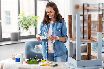 Image showing woman applying solvent to rag at home