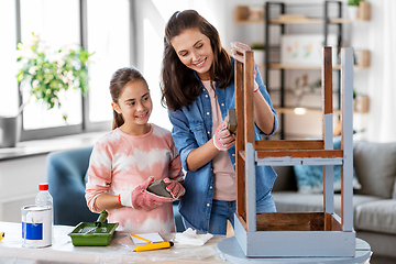 Image showing mother and daughter sanding old table with sponge