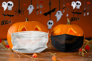 Image showing carved pumpkins or jack-o-lanterns in masks