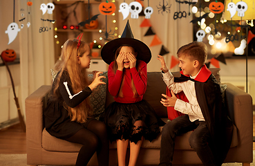 Image showing kids in halloween costumes playing at home