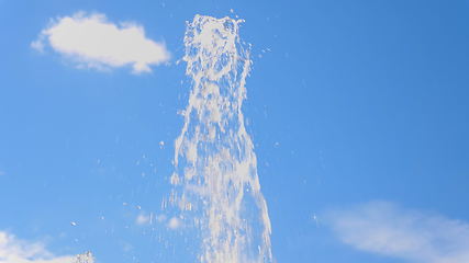 Image showing Top fountain water against on the blue sky.