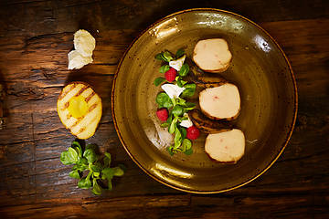 Image showing Chicken fillet with greens, cheese, raspberry and pear roast