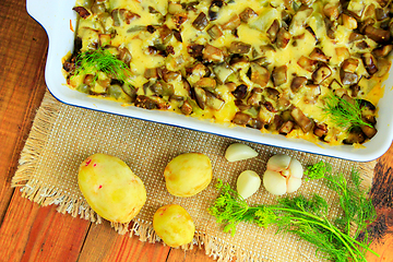 Image showing Baked potato with slices of eggplant cheese and garlic