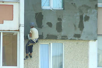 Image showing specialist carring out warming of many-storied building