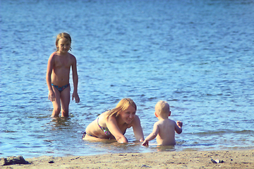 Image showing mother playing with her daughters at the river