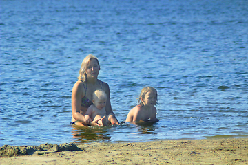 Image showing mother taking a bathe with her daughters at the river