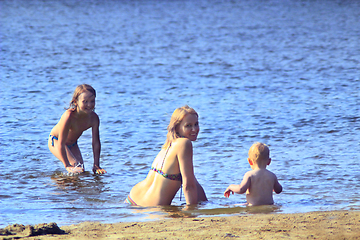 Image showing mother playing with her daughters at the river