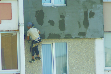 Image showing specialist carring out warming of many-storied building