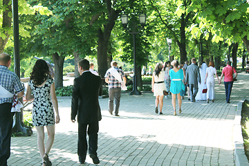 Image showing People have a rest in park with greater trees