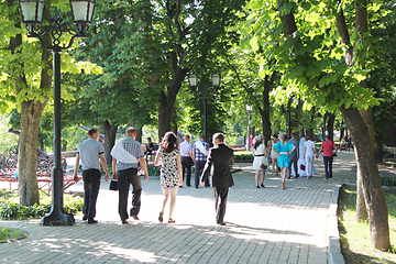 Image showing People have a rest in park with greater trees