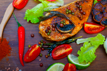 Image showing wood fired hoven cooked chicken breast on wood board