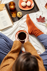 Image showing woman drinking coffee at home in autumn