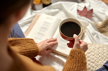 Image showing woman drinking coffee and reading book in autumn