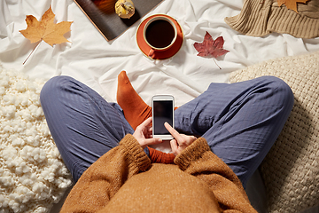 Image showing woman with smartphone at home in autumn