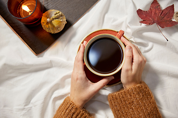 Image showing hands of woman with cup of coffee in autumn