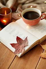 Image showing cup of coffee, book on window sill in autumn