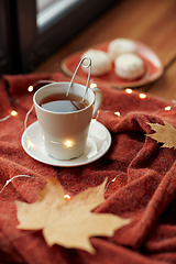 Image showing cup of tea and autumn leaves on window sill