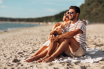 Image showing happy couple chilling on summer beach