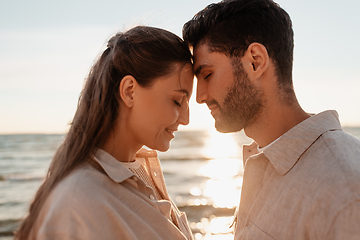 Image showing happy couple with closed eyes on summer beach