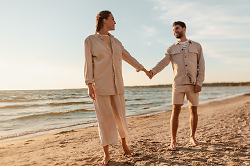 Image showing happy couple holding hands on summer beach