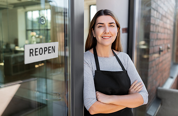 Image showing happy woman with reopen banner on door glass