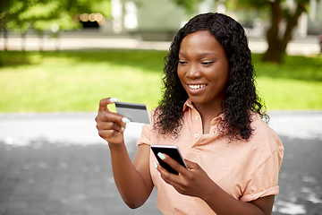 Image showing african woman with smartphone and credit card