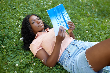 Image showing african student girl reading math textbook