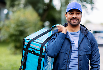 Image showing happy smiling indian delivery man with bag in city