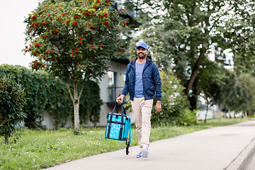 Image showing indian delivery man with bag walking in city