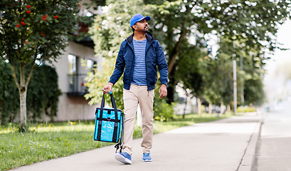 Image showing indian delivery man with bag walking in city