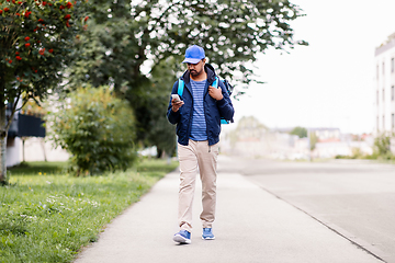 Image showing indian delivery man with bag and phone