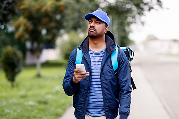 Image showing indian delivery man with bag and phone