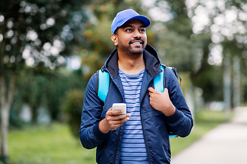 Image showing smiling indian delivery man with bag and phone