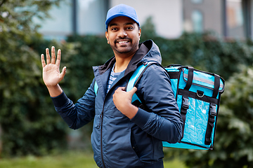 Image showing happy smiling indian delivery man with bag in city