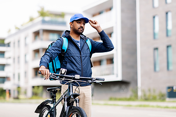 Image showing indian delivery man with bag and bicycle in city