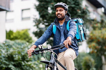 Image showing indian delivery man with bag riding bicycle