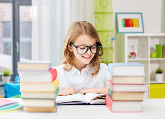 Image showing happy smiling student girl reading book at home