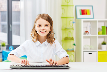 Image showing happy student girl with keyboard at home