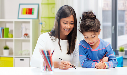 Image showing happy mother and daughter drawing at home