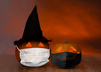 Image showing carved pumpkins or jack-o-lanterns in masks